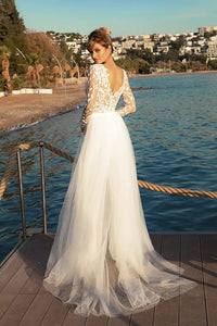 Experience the feminine grace of the Combinaison Nadine exquisite wedding gown. Embellished with opulent appliques and a detachable train, this elegant jumpsuit will make you the center of attention. Enjoy the timeless glamour of luxury fashion on your special day.