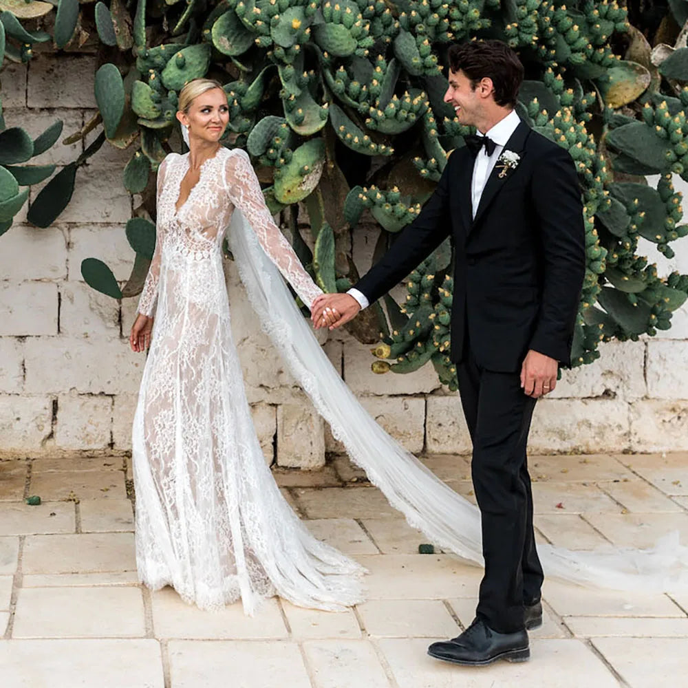 Capture a sophisticated look for your special day with the Robe Esme. Crafted in sheer lace, this plus size A line wedding gown features deep v neckline, long sleeves and boho maxi hipple design for a rustic yet luxe look. Perfect for photography, the dress is custom made to ensure a perfect fit. Create a timeless bridal look with Robe Esme.