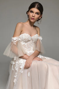 Elevate your bridal look with the Remy Gown. Featuring sweetheart neckline appliques, a chapel train, and a stunning silhouette, it's your chance to make a bold statement on your special day. Dare to be unique!
