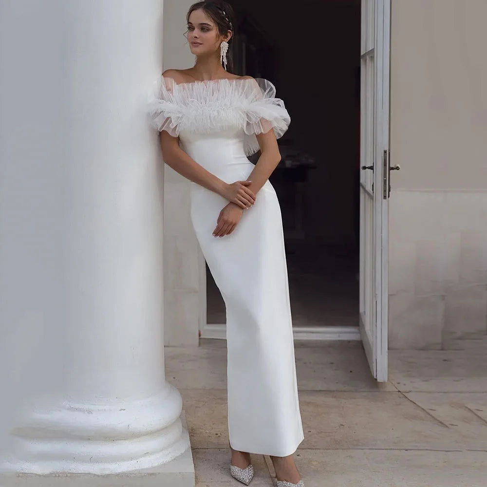 Indulge in the feminine allure of our Robe Allura. This mermaid wedding dress features elegant pleats, a flattering off-the-shoulder design, and a sophisticated backless silhouette. Made from premium elastic satin, this dress is the epitome of luxury and will make any bride feel like royalty.