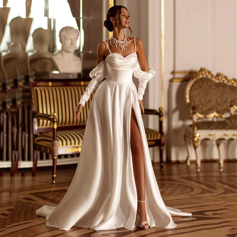 This elegant beach boho wedding dress, known as the Robe Arlette, is perfect for the modern, chic bride. With a sweetheart neckline, intricate bead and sequin detailing, and flattering pleats, this dress exudes grace and sophistication. Make a statement on your special day with this stunning dress.