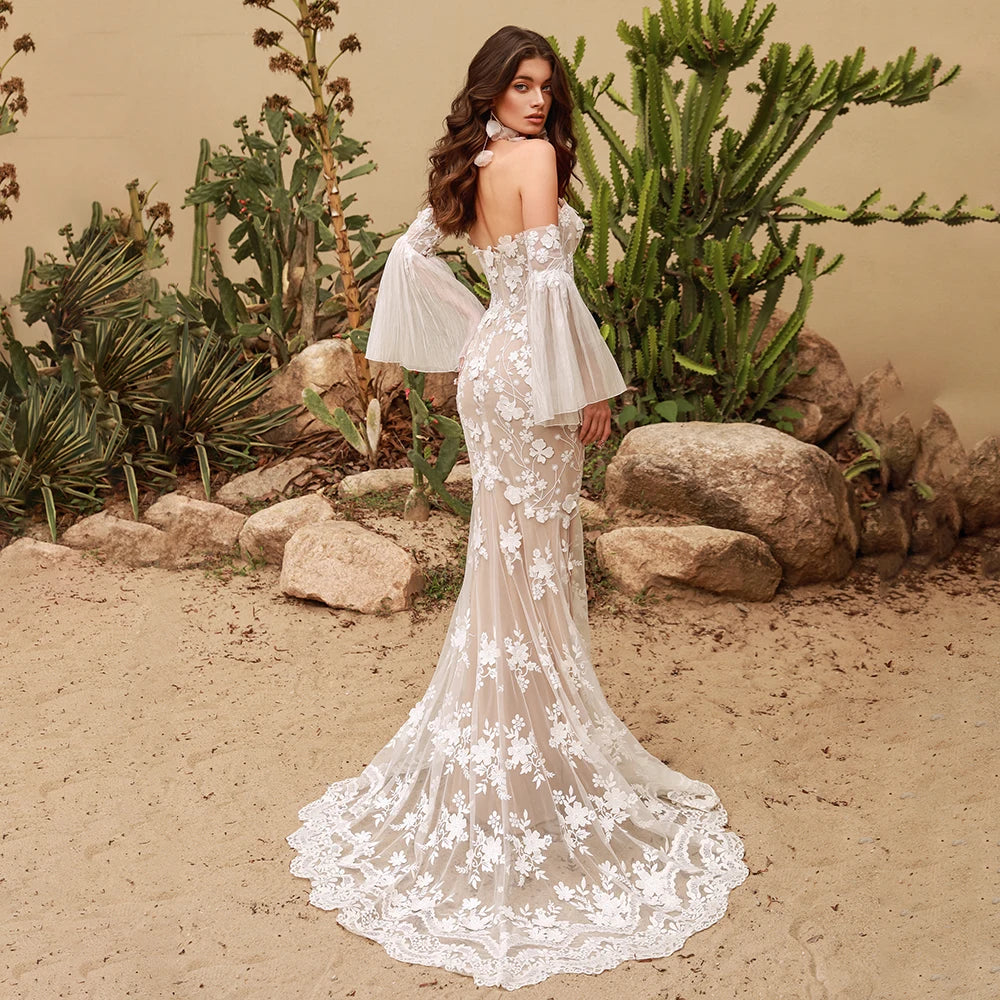 This stunning Robe Calais features mermaid silhouette, detachable chiffon bell sleeves, and intricate lace details. Perfect for a wedding dress that allows for easy customization and effortless elegance. Feel like a mermaid on your special day with this gorgeous piece.