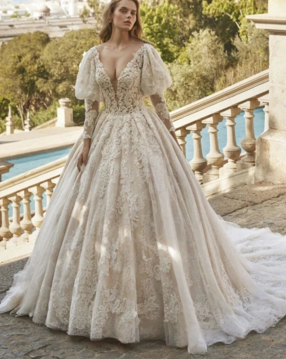 Indulge in pure elegance with our Robe Jadore. This classic applique robe features sparkling beadings and graceful long sleeves, perfect for a romantic bridal look. Embrace the luxurious ball gown silhouette and make a statement on your special day.