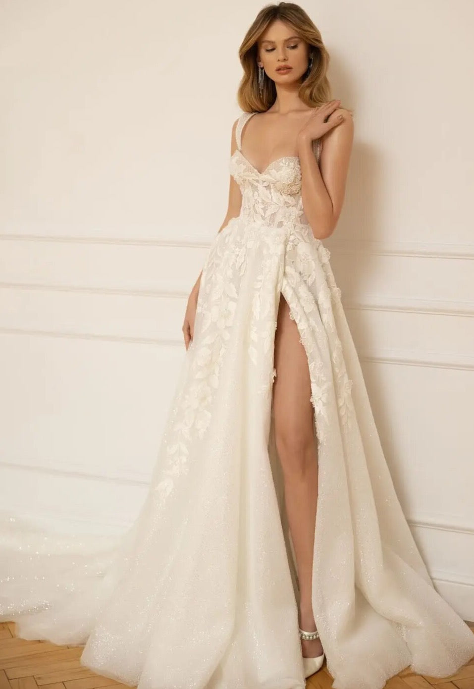 Wrap yourself in luxury with our elegant Robe Remi. The A-line silhouette and spaghetti straps gown give off a chic vibe, while the open leg adds a touch of fantasy. Made with exquisite craftsmanship, this gown is perfect for your dream wedding.