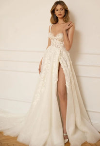 Wrap yourself in luxury with our elegant Robe Remi. The A-line silhouette and spaghetti straps gown give off a chic vibe, while the open leg adds a touch of fantasy. Made with exquisite craftsmanship, this gown is perfect for your dream wedding.