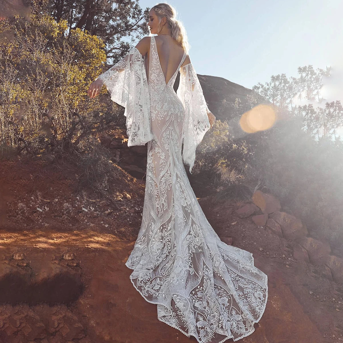 Unleash your inner mermaid with Dress Marina! Its long elastic batwing sleeves and elegant mermaid silhouette make it the ideal lace wedding dress for beachside nuptials. And let's not overlook the dazzling sequin accents - you'll radiate like the night sky in this captivating gown.