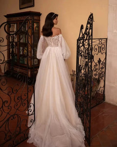 Introducing the Robe Marlene - the perfect bridal gown for those who want to make a statement! With its long full puff sleeves and A-line silhouette, this gown will make any bride feel like a fairy tale princess.