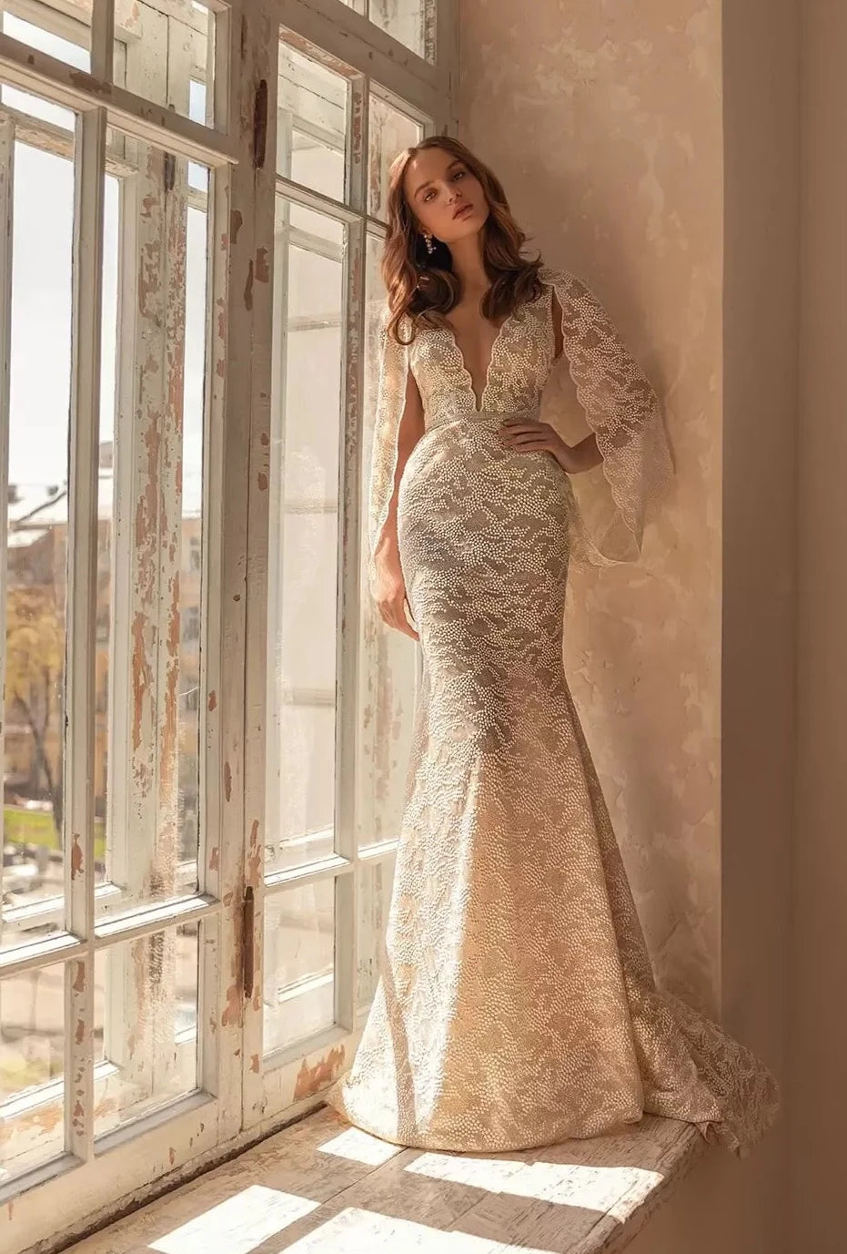 Experience elegance and grace with our Dress Anoushka. Designed for the modern bride, this dress features a flattering V-neckline, delicate spaghetti straps, and intricate lace details. Walk down the aisle confidently in this stunning sheath gown, perfect for any wedding.