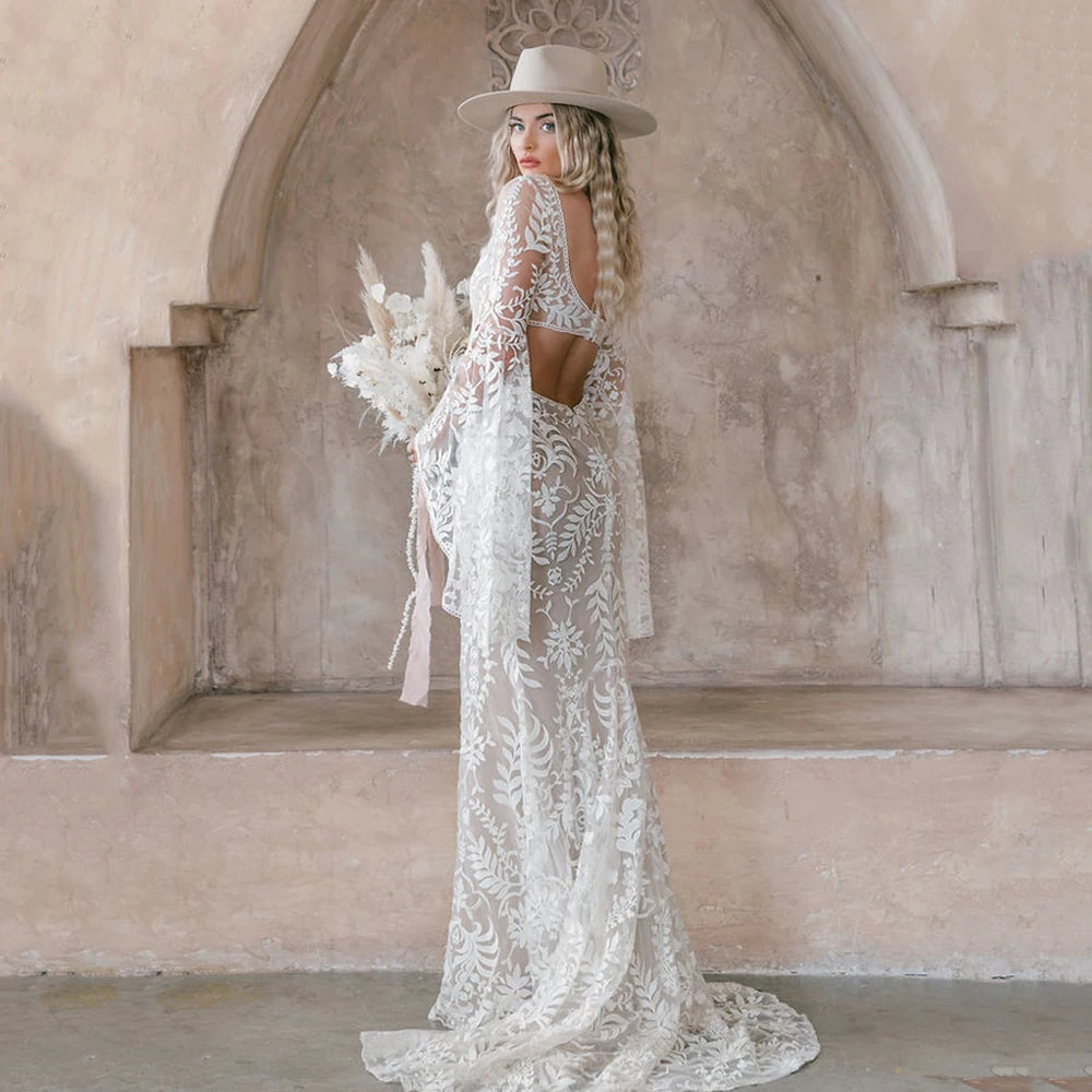 Our Robe Margaux dress is a timeless piece built for special occasions. This plus-size custom-made design features a lace square neck, long bat sleeves, backless side hollow cutouts, and a mermaid rustic bridal gown. Create a one-of-a-kind look that is perfect for your special day.