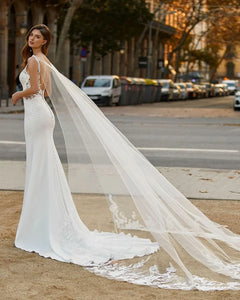 Make a splash on your big day with the Robe Desi. This elegant lace mermaid wedding dress is perfect for the boho bride, featuring a satin bodice and sleeveless design. Show off your curves and dance the night away in this stunning and unique gown.