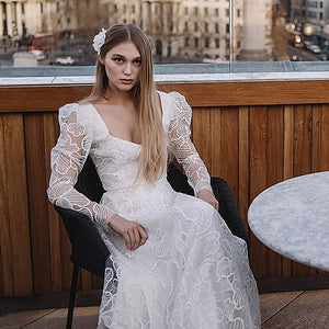 Discover the perfect wedding gown for your special day with Robe Monet's Floral Lace Sequined Square Neck gown. Sheer long sleeves and a low cut two pieces crop top adorn the modern chic look. Plus size design ensures an elegant and stylish fit for every bride. Make your dream come true in this beautiful bridal dress!