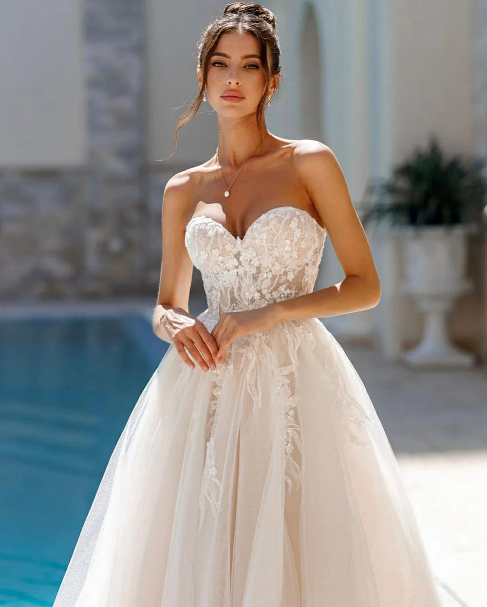 Indulge in the timeless elegance of the Robe Ariane. Adorned with intricate lace and sweet appliques, this A-Line bridal gown is fit for a princess on her special day. With a sweetheart neckline, it exudes grace and sophistication. Your fairy tale wedding awaits.