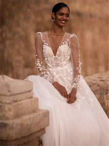 Indulge in timeless elegance with our Robe Nina. Featuring a delicately crafted lace design and long sleeves, this wedding gown is the perfect choice for your special day. Experience the luxury and sophistication of our exclusive collection.