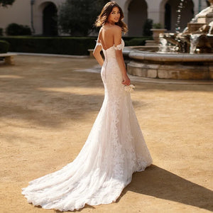 Indulge in luxury and sophistication with our Robe Raine. This elegant off-the-shoulder lace mermaid wedding dress boasts a sweetheart neckline and a sweeping train. Perfect for the discerning bride who wants to make a statement on her special day. Made for women who appreciate timeless beauty and exquisite craftsmanship.