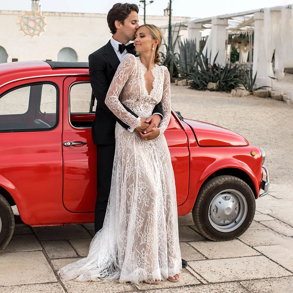 Capture a sophisticated look for your special day with the Robe Esme. Crafted in sheer lace, this plus size A line wedding gown features deep v neckline, long sleeves and boho maxi hipple design for a rustic yet luxe look. Perfect for photography, the dress is custom made to ensure a perfect fit. Create a timeless bridal look with Robe Esme.