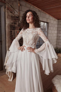 Indulge in luxury with the exquisite Dress Chamilla. This stunning wedding dress features an empire silhouette, elevated by a boat neckline and intricate lace detailing. The flowing chiffon fabric adds a touch of romance, making it the perfect choice for bridal gowns. Walk down the aisle in style and grace.