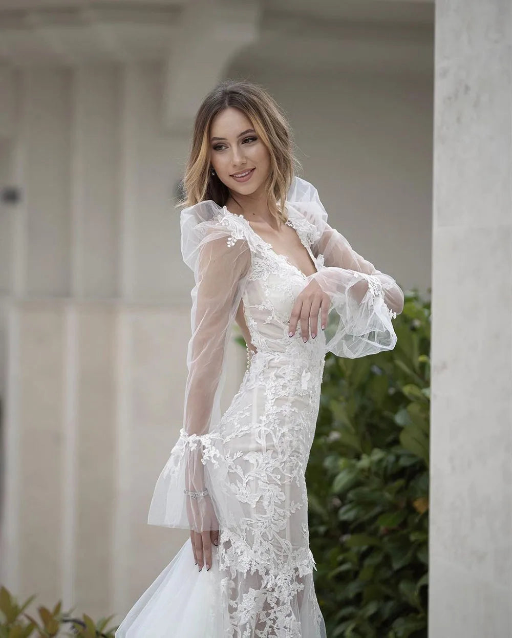 Elevate your bridal style with the Robe Pascale. This boho mermaid wedding dress features a V-neckline and puff long sleeves for a unique and elegant look. Made with high-quality materials, it offers both comfort and style on your special day. Embrace your inner mermaid and make a statement with this stunning bridal gown.