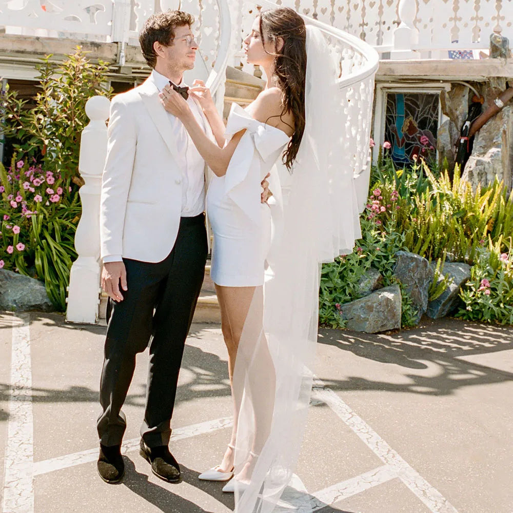 Look dreamy in this Mini Bridal Robe Lisette! Featuring a simple satin sheath fit with bow and custom-made elastic straps, you'll be the glamourous star of the show on your special day. Slip into this above-knee beauty and feel like the queen you are!