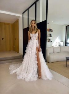 Get ready to walk down the aisle in style with our Robe Marlenne. This stunning dress features delicate flowers, a flattering square neckline, and elegant spaghetti straps. The A-line silhouette and lace detailing add a touch of romance to your special day. Say "I do" to this perfect wedding dress.