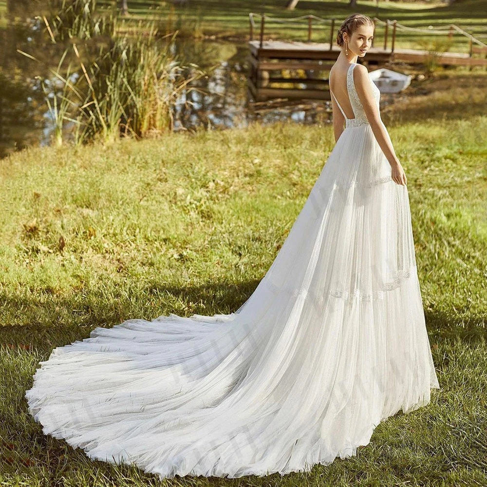 The Robe Dorothy is a stunning beach wedding dress that effortlessly combines simplicity with bohemian style. Made with delicate lace and tulle, it exudes a sense of elegance and grace. Perfect for a boho-chic bride, this dress is sure to make a statement on your special day.