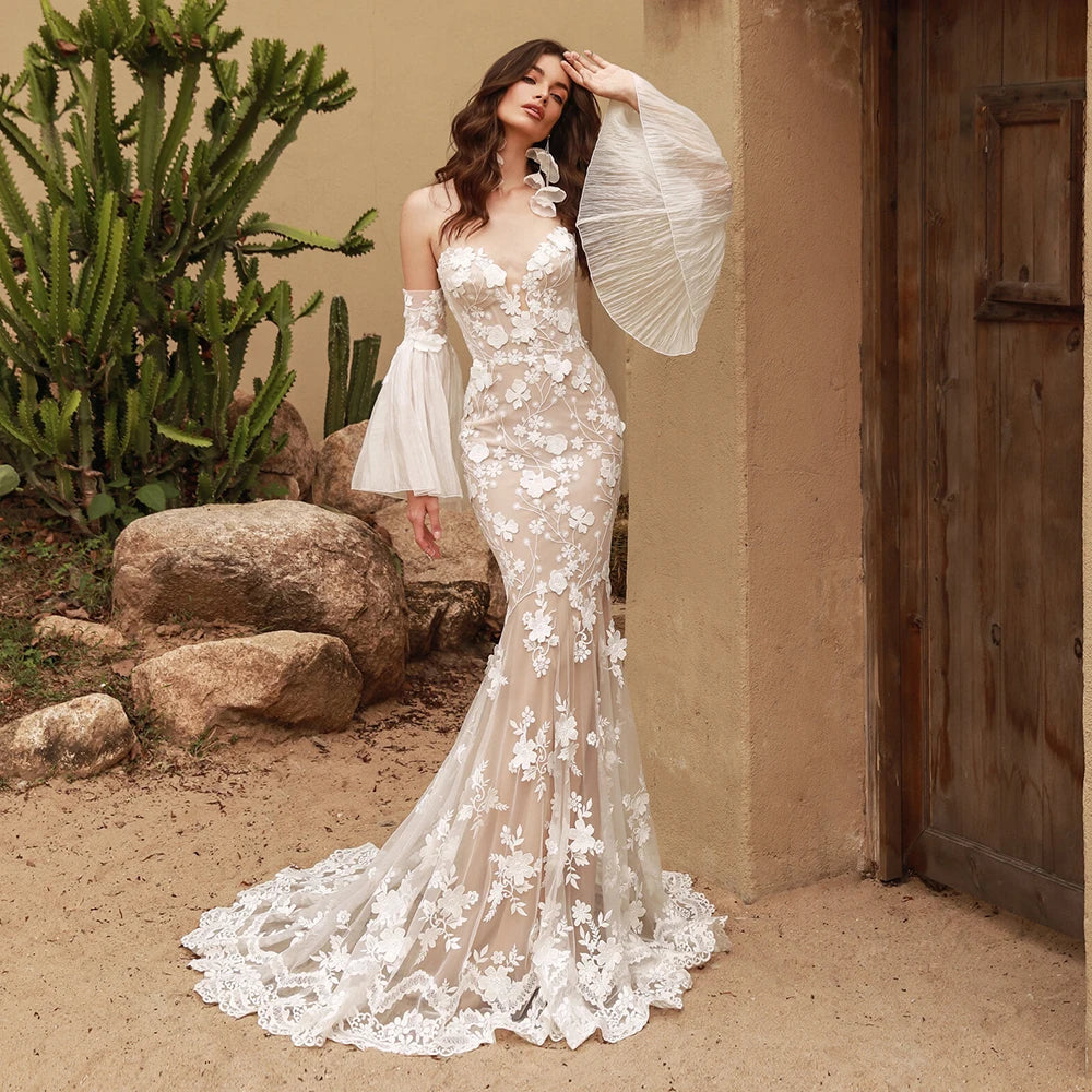 This stunning Robe Calais features mermaid silhouette, detachable chiffon bell sleeves, and intricate lace details. Perfect for a wedding dress that allows for easy customization and effortless elegance. Feel like a mermaid on your special day with this gorgeous piece.