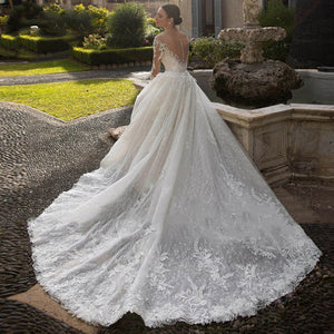 Be the talk of the aisle in this luxurious, vintage-style Harriett Dress. Crafted from exquisite embroidered lace and net with a detachable train, this statement gown features a V-neck sleeveless silhouette to exude sophistication and femininity. Perfect for a one-of-a-kind wedding look with timeless grace, the Harriett Dress is a special and exclusive choice.
