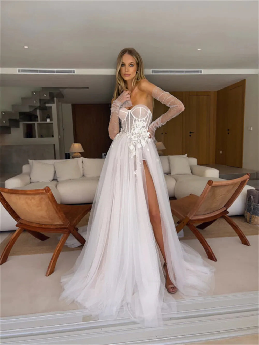 This show-stopping dress features a sweetheart neckline, long sleeves, and an enticing slit skirt that will have everyone, from your mother-in-law to your bestie, wanting to sweep you into a twirl.