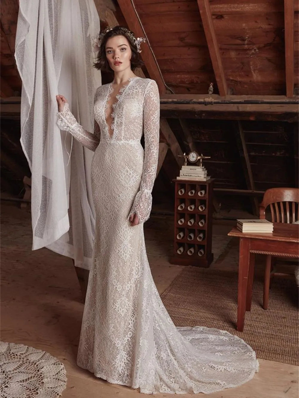 The Aveline wedding dress is perfect for looking beautiful and confident on your special day. The sexy mermaid cut and deep V neckline give you an elegant silhouette while the lace detail and long sleeves add a romantic touch. Create your dream bridal look with this stunning gown.
