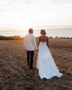 Radiate grace and elegance on your special day with our Dress Caro. This strapless A-line bridal dress is designed to accentuate your curves and leave you feeling like a true bride. With its exquisite craftsmanship and delicate details, this dress is a must-have for any sophisticated woman. Say "I do" in style with our robe de mariée.