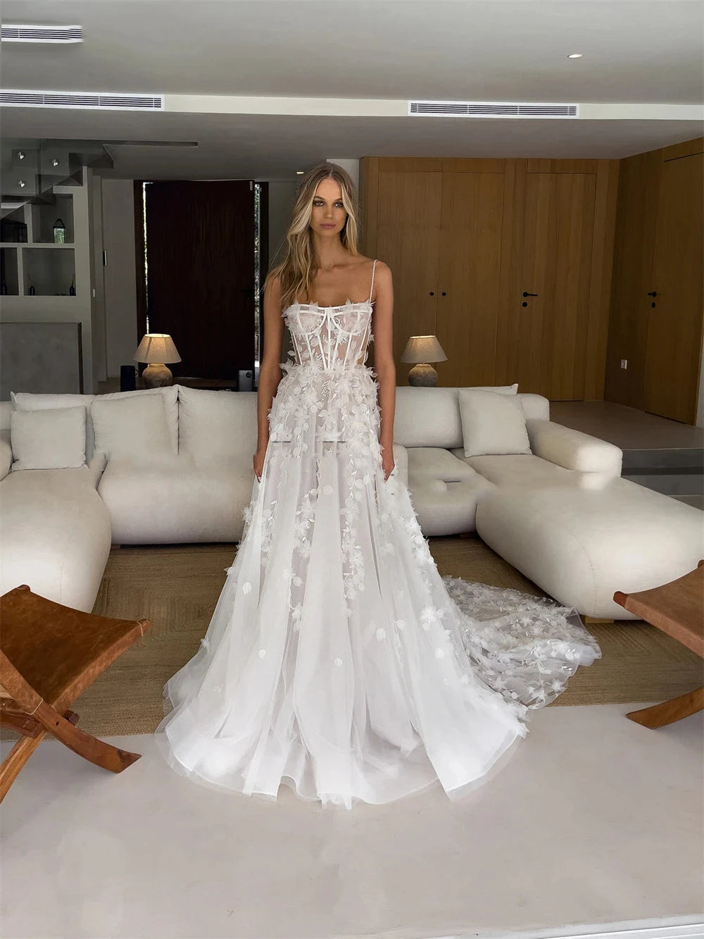 Indulge in pure elegance with Dress Anje. This off-shoulder wedding dress features a mermaid silhouette and a sweeping train, creating a majestic and sophisticated look. The sleeveless design adds a touch of modernity, making it perfect for the fashion-forward bride. Every detail is thoughtfully designed for a truly stunning statement on your special day.