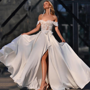 Introducing the elegant and timeless Robe Léonie. This stunning bridal gown features intricate sequins and delicate lace appliques, designed to make you shine on your special day. With a side split design, this dress adds a modern touch to a classic silhouette. Make a statement with Robe Léonie.