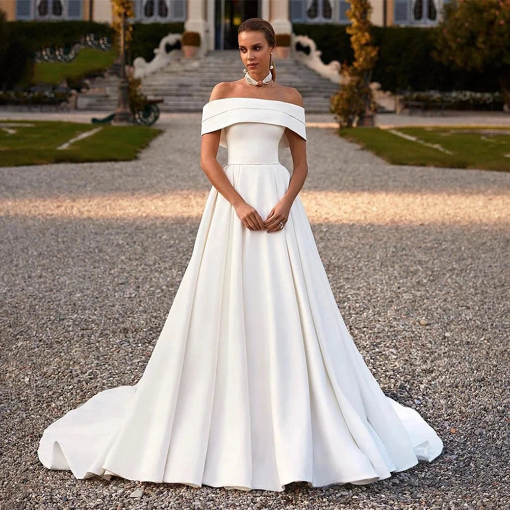 This stunning off-the-shoulder mermaid wedding dress exudes elegance and sexiness. With its flattering silhouette and mopping design, it's perfect for any bride who wants to make a statement on her special day. Make your wedding unforgettable with Dress Amelia!