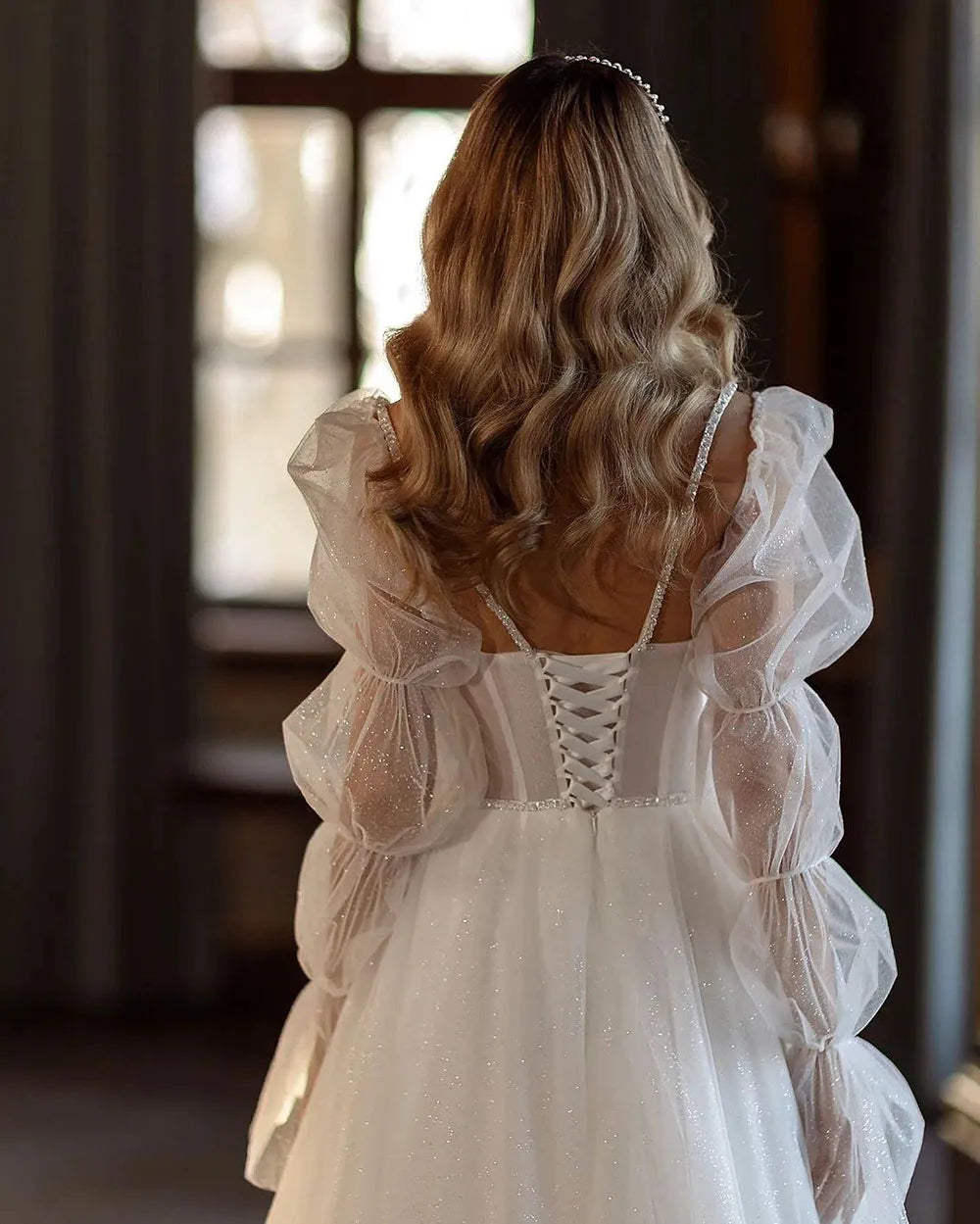 Indulge in the timeless elegance of our Robe Gena. This vintage-inspired wedding dress features a sweetheart neckline, puff sleeves, and a flattering A-line silhouette. Glitter detailing adds a touch of glamour to this sophisticated gown. Make a statement on your special day with this exclusive piece.