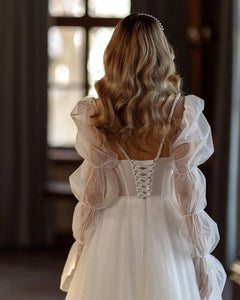 Indulge in the timeless elegance of our Robe Gena. This vintage-inspired wedding dress features a sweetheart neckline, puff sleeves, and a flattering A-line silhouette. Glitter detailing adds a touch of glamour to this sophisticated gown. Make a statement on your special day with this exclusive piece.