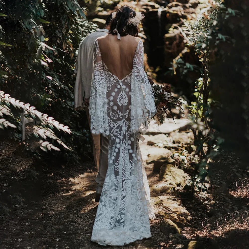 Expertly crafted for the modern and elegant bride, the Robe Anaise features delicate lace detailing and a sleek, form-fitting silhouette. Its long batwing sleeves and high neck add a touch of bohemian flair, while the custom made double slip with slit ensures comfort and movement on the big day. Complete your bridal look with this two-piece, backless sheath gown.