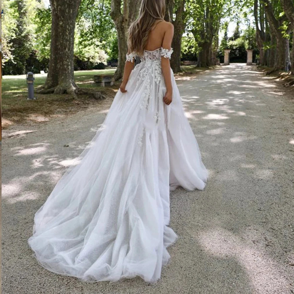 Be the picture of elegance in our Dress Isabella. This beautiful mermaid style wedding dress features an off-shoulder design, sleeveless top, and a high split for a sexy touch. With a sweetheart neckline and backless detail, you'll stun from every angle. Make a statement on your special day with this elegant bridal gown.