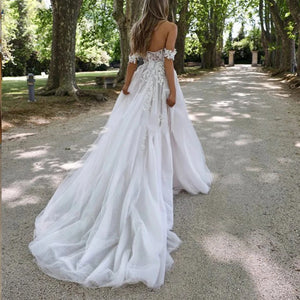 Be the picture of elegance in our Dress Isabella. This beautiful mermaid style wedding dress features an off-shoulder design, sleeveless top, and a high split for a sexy touch. With a sweetheart neckline and backless detail, you'll stun from every angle. Make a statement on your special day with this elegant bridal gown.