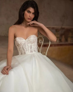 Unleash your playful and elegant side with Robe Eva! This A-line bridal gown features stunning appliques, perfect for your big day. Make a statement with this tres elegante robe, designed for the fashion-forward bride. Say oui to style!