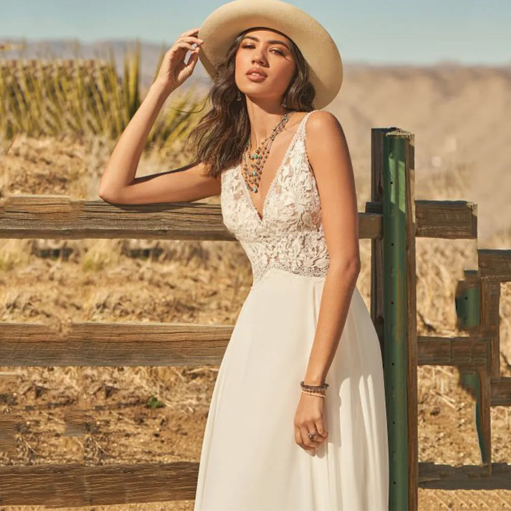 The Dress Scarlett is a stunning bohemian wedding dress designed with a V-neck and delicate lace appliques. The A-line silhouette and flowy chiffon fabric add an ethereal touch, while the backless design and button train bring a modern and romantic twist. Perfect for a boho bride looking for a unique and beautiful gown.