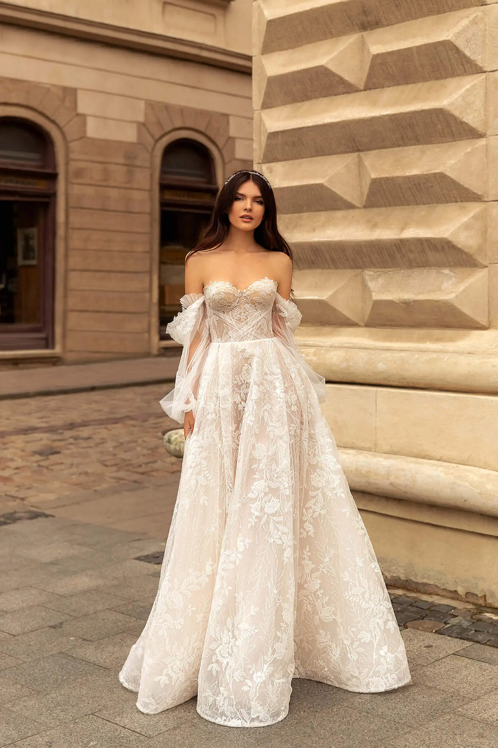 Indulge in luxury with our Robe Rachelle. This elegant wedding dress features delicate lace, long sleeves and a timeless design to make you feel like a true bride. Perfect for the contemporary woman who wants to make a statement on her special day. Step into sophistication with our Robe Rachelle.