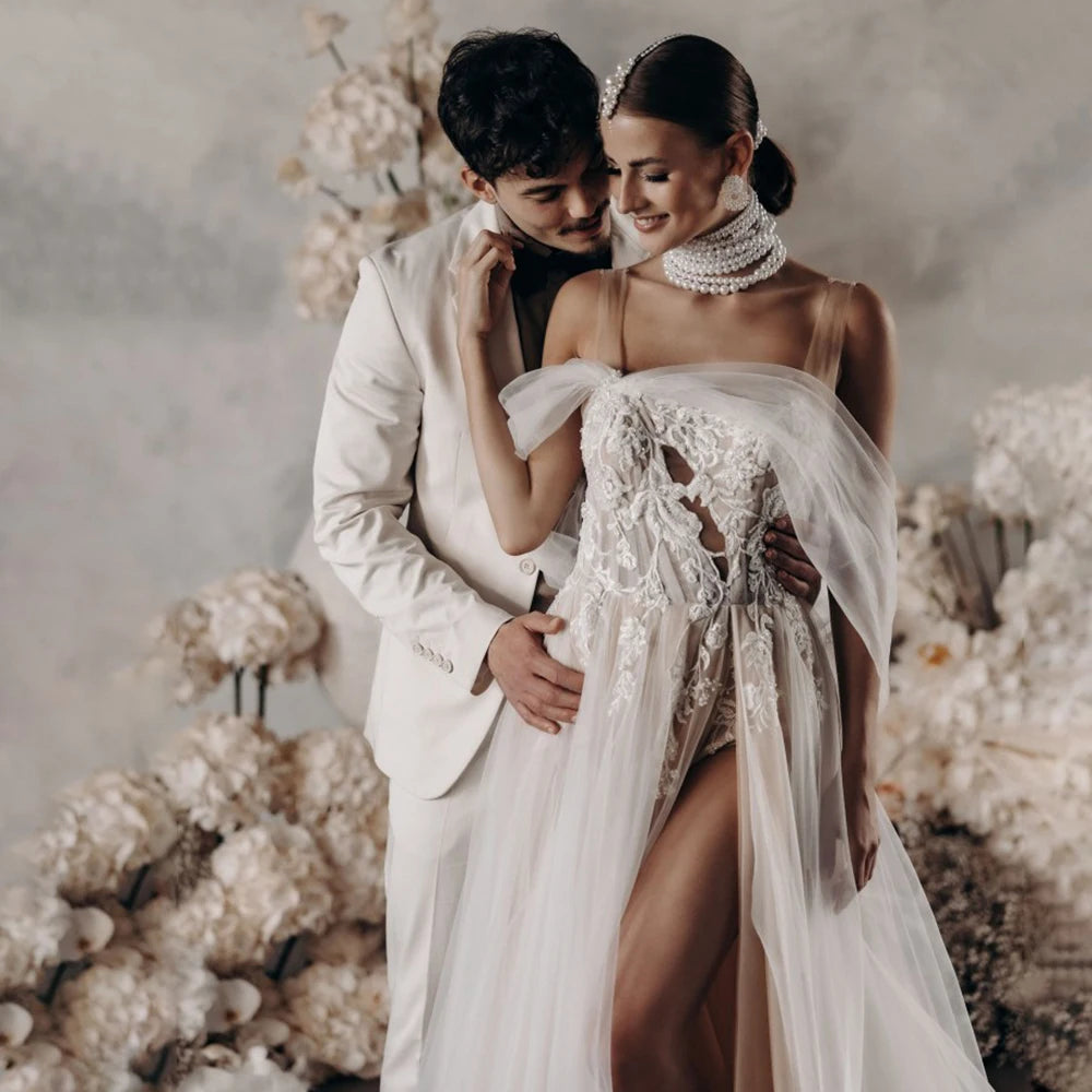Elevate your wedding day with the Robe Satine, designed with seduction in mind. The off shoulder, high split design is delicately adorned with tulle appliques, shirred sleeves, and intricate beading lace. Its silhouette is perfect for maternity photoshoots and will make you feel like a goddess on your special day.