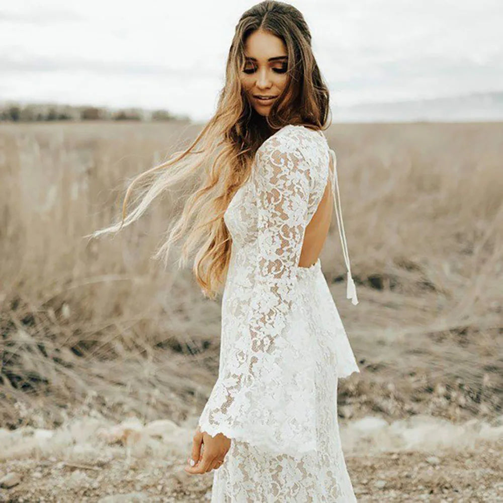 Indulge in luxury with our Dress Arabelle. Showcasing delicate scalloped lace and a plunging v-neck, this wedding dress is customizable with long bell sleeves and tassled ties at the back for a bohemian touch. Cutouts add a modern twist to this timeless piece. Perfect for the sophisticated and fashionable bride.