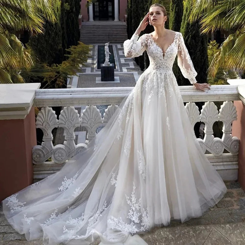 Elevate your special day with the Robe Khloe. This luxury wedding dress features long sleeves for a sophisticated touch, while the V-neck and backless design add a hint of sexiness. Indulge in the premium quality and craftsmanship of this bridal gown, making you feel like a true goddess on your wedding day.
