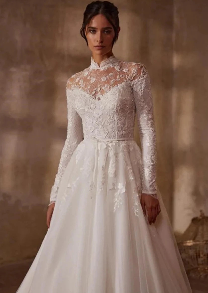 Indulge in timeless elegance with the Robe Mercer. This luxurious vintage wedding dress features intricate lace detailing, a stunning ball gown silhouette, and long sleeves for a touch of grace and sophistication. Perfect for the bride seeking a romantic and classic look on her special day.