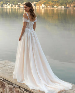 Captivate the room in this exquisite Robe Gigi. Crafted with luxurious lace appliques, a sweetheart neckline, and a figure-defining corset bodice, this romantic princess wedding gown looks as if it were poured from a Dutch Masters painting. Let the delicate tulle skirt and spaghetti straps drape gracefully, for a look that is both elegant and timeless.