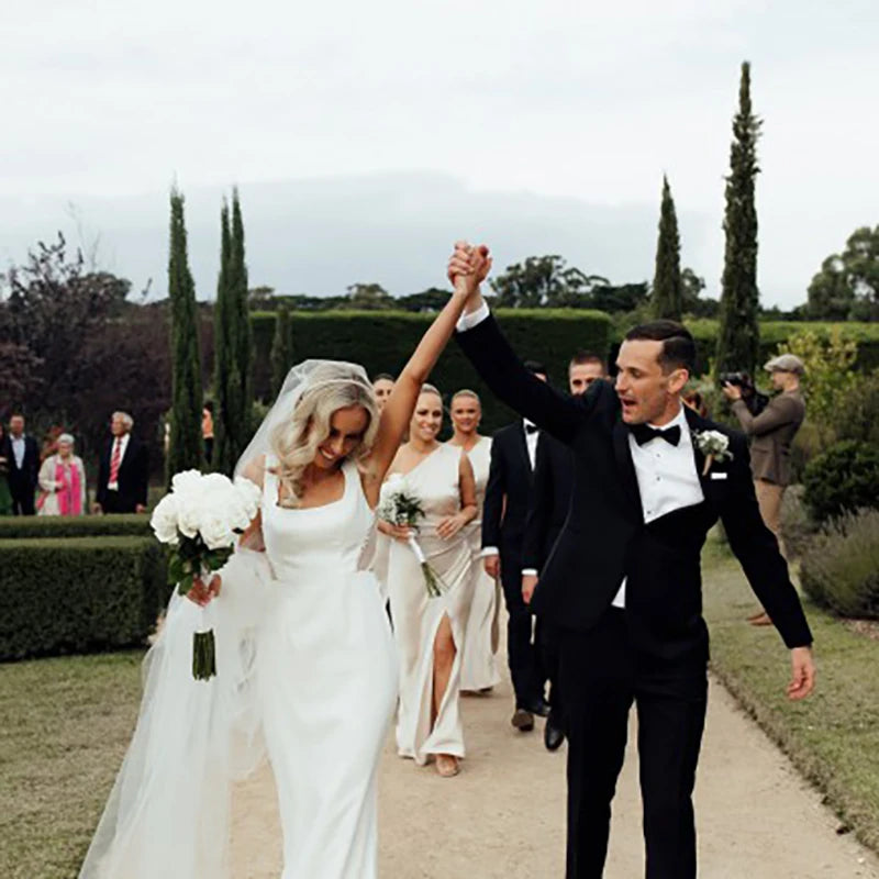 Enjoy a timeless, romantic look in the Marianne robe! Featuring a square neck with crepe illusion tulle and a hollow back sheath, your simple bridal gown will be the star of the show. Plus, you can customize with ribbon and white satin for a truly unique look. High five!
