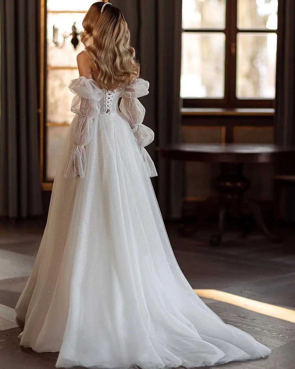 Indulge in the timeless elegance of our Robe Gena. This vintage-inspired wedding dress features a sweetheart neckline, puff sleeves, and a flattering A-line silhouette. Glitter detailing adds a touch of glamour to this sophisticated gown. Make a statement on your special day with this exclusive piece.
