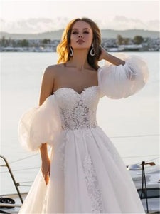 Elevate your special day with our Robe Rene, a luxurious lace ball gown that exudes elegance and sophistication. The off-shoulder design adds a touch of romance, making you feel like a modern-day princess. Perfect for a wedding or any lavish event. Experience the ultimate in style and grace with our Robe Rene.
