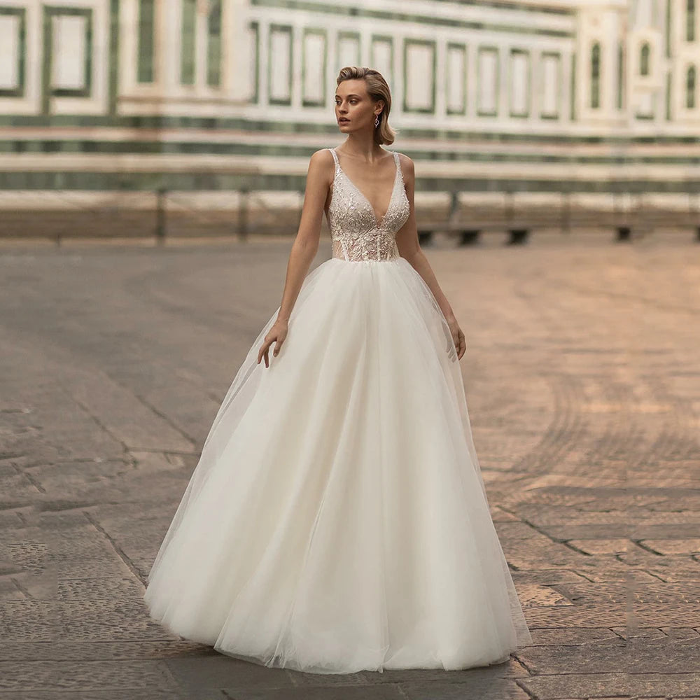 Indulge in pure elegance with the Robe Emeraude. This wedding dress features a seductive V-neck, delicate lace and luxurious tulle fabric, and a stunning backless design fit for a princess. Perfect for the sophisticated bride who wants to make a statement on her special day.