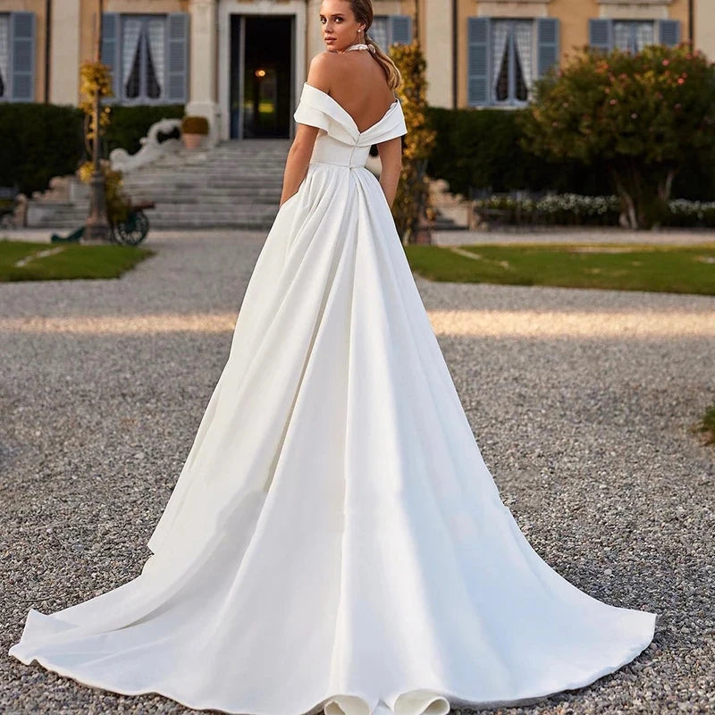 This stunning off-the-shoulder mermaid wedding dress exudes elegance and sexiness. With its flattering silhouette and mopping design, it's perfect for any bride who wants to make a statement on her special day. Make your wedding unforgettable with Dress Amelia!